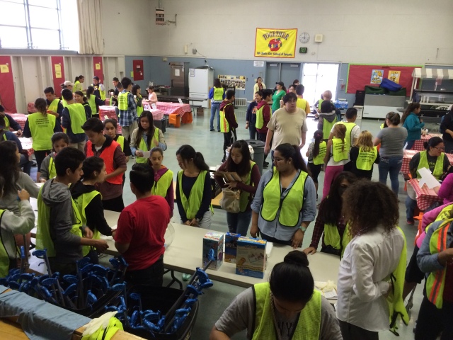 VOLUNTEERS LINE UP FOR LITTER GRABBER CHECK OUT